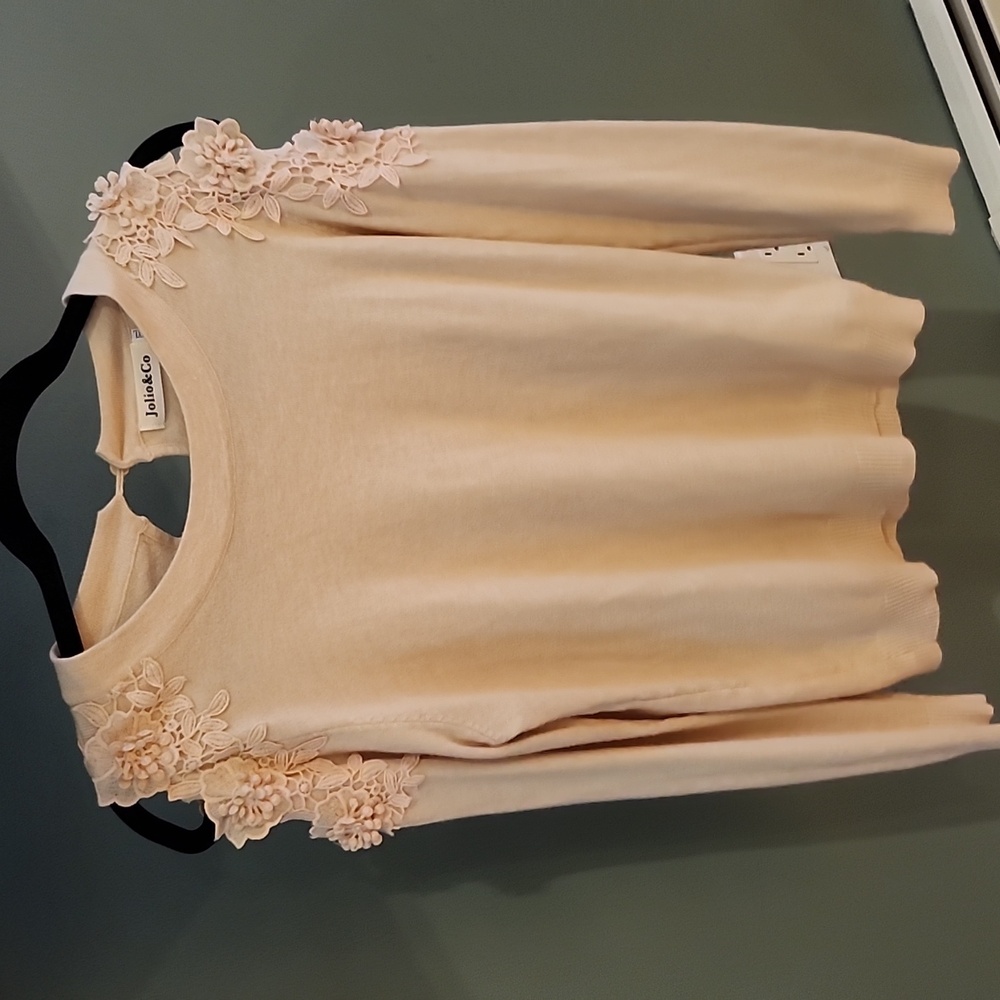 Cold shoulder knit top with floral applique blush color